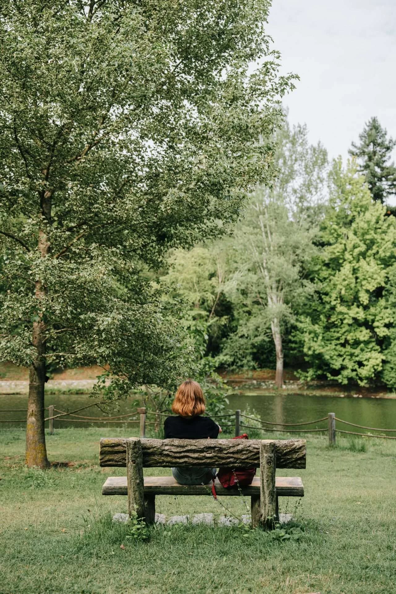 Woman relaxing with her eyes closed and a hand on her chest.